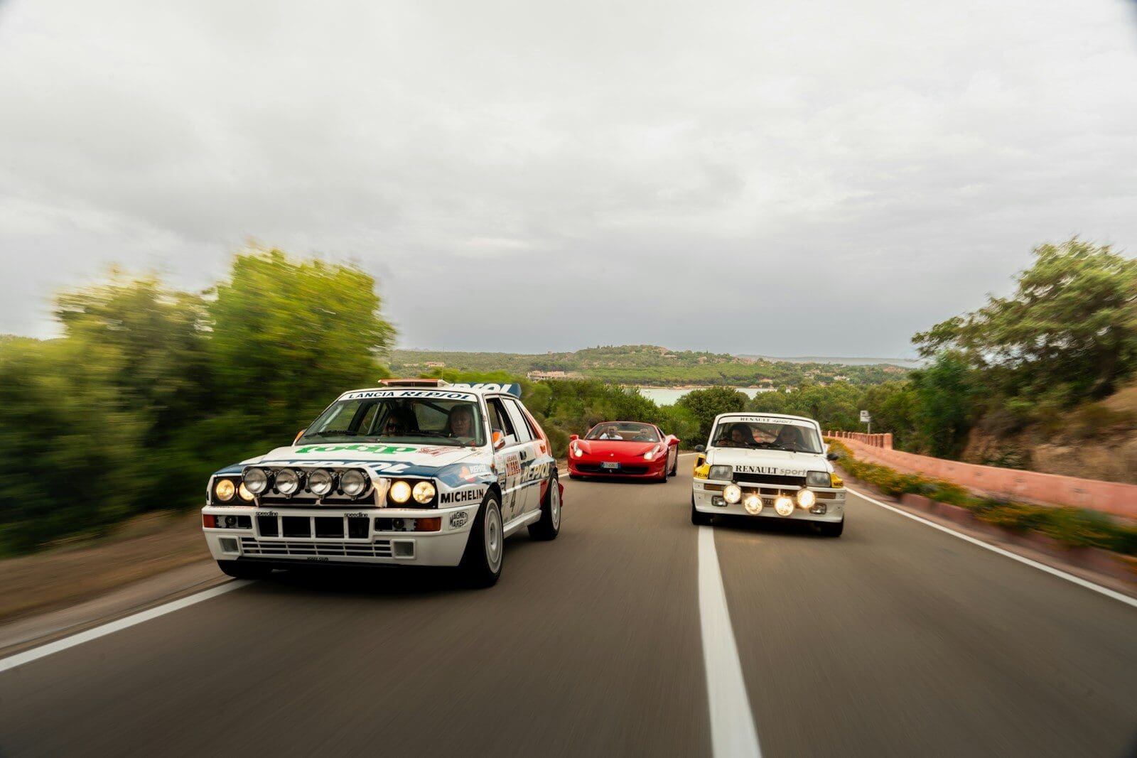 a couple of cars driving down a road next to each other